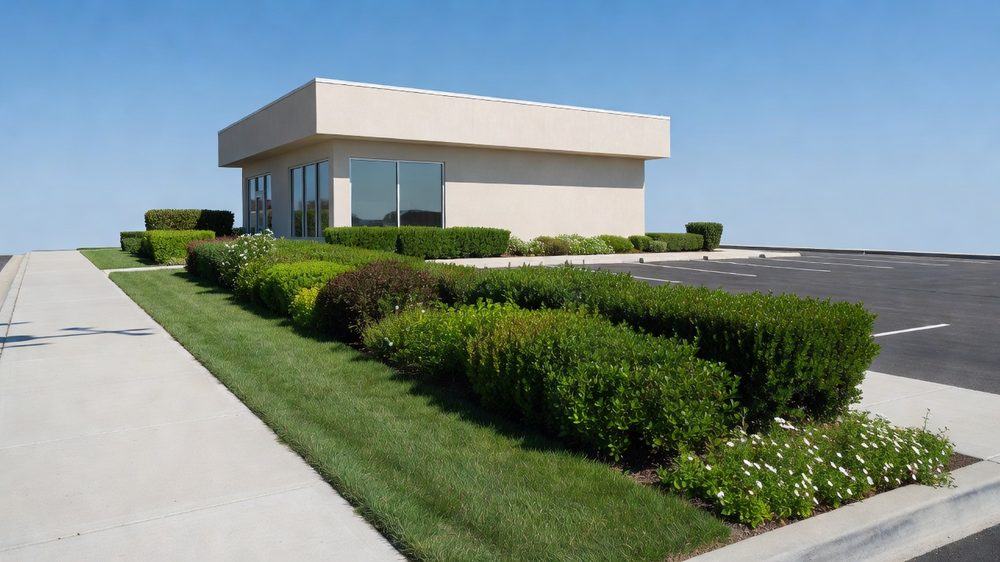 Neatly maintained lawn and beds in front of a small office building